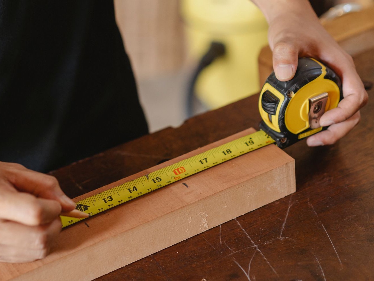 A hardwood board being measured during a specification check